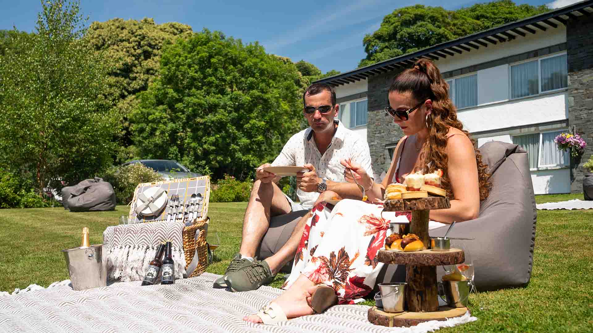 Couple enjoying an alternative afternoon tea picnic on the lawns of the Wild Boar