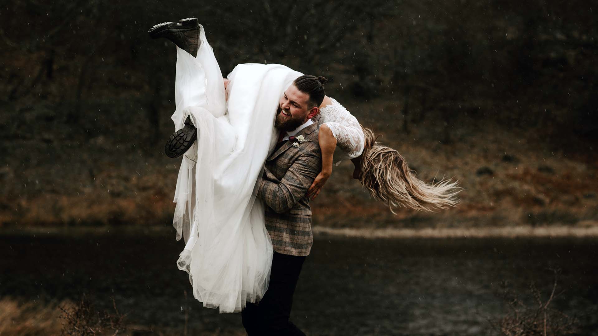 Newly wed couple by the woodland tarn