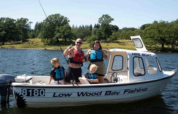 Family on a fishing boat out on lake Windermere