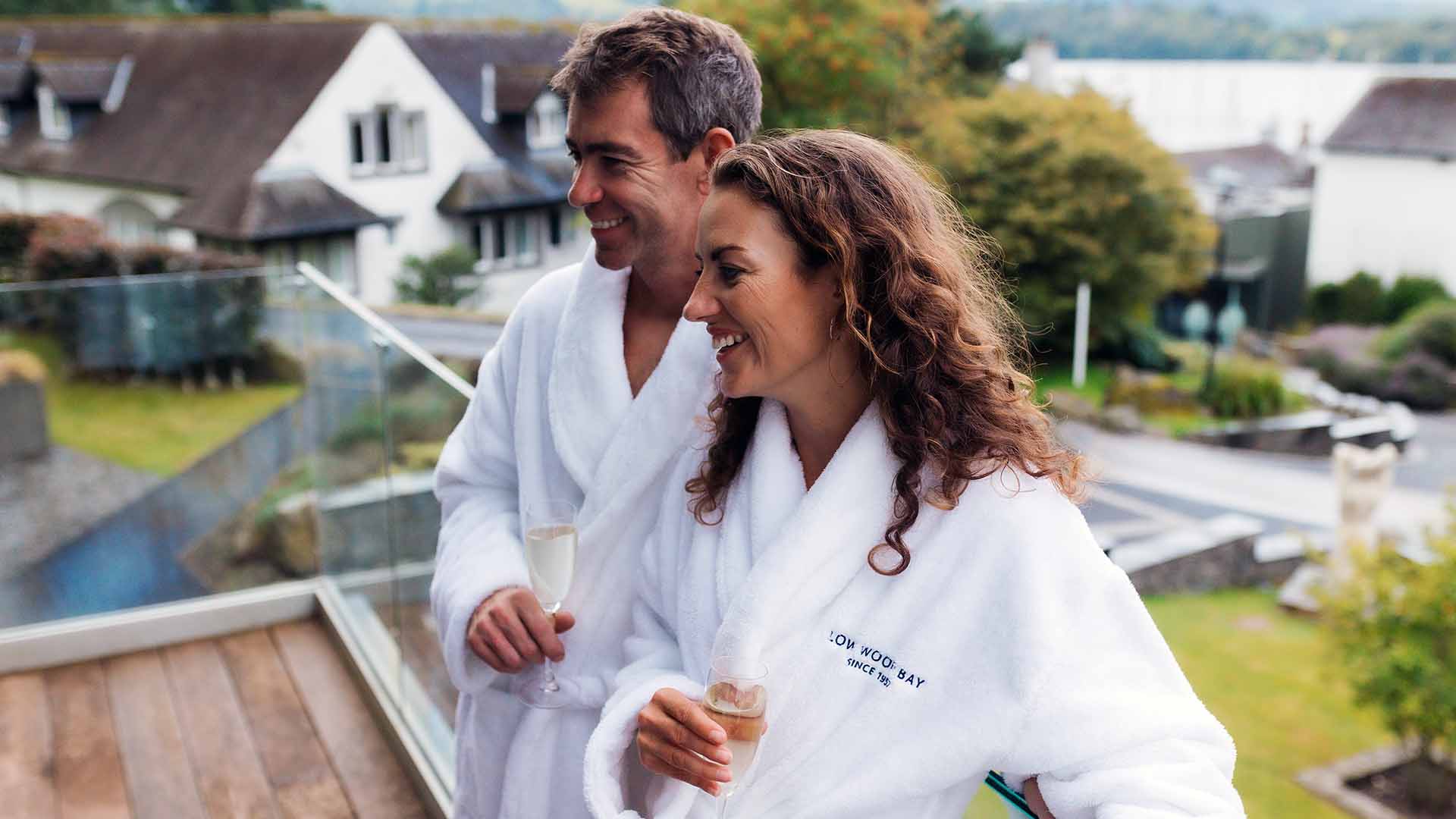 Couple stood on the balcony of an Oak Suite room at the Winander Club at Low Wood Bay