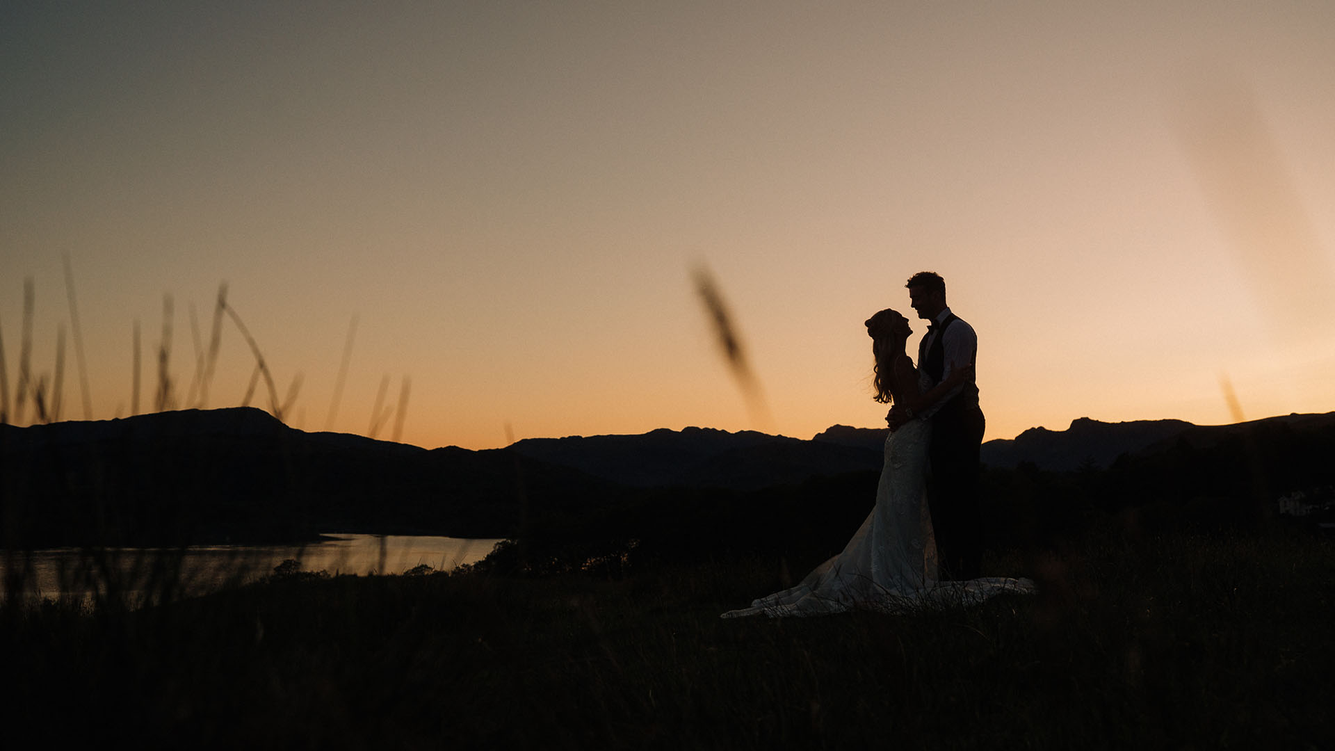 Louise and James silhouetted against the setting sun