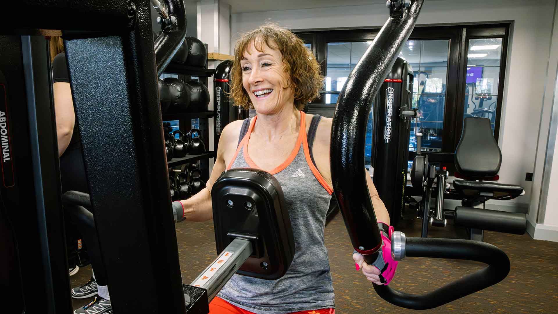 Woman using the gym equipment at the health club