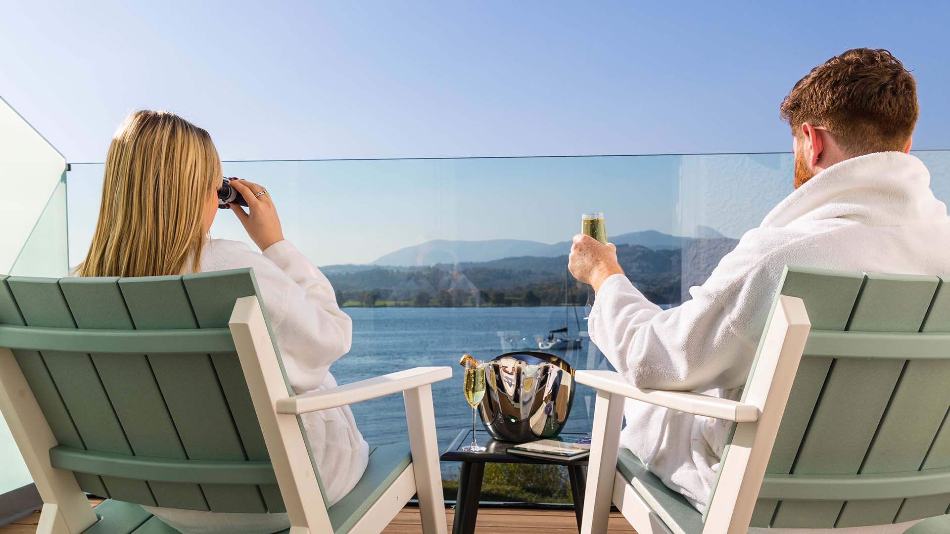 Couple on balcony of a hazel lake view room with balcony at Low Wood Bay