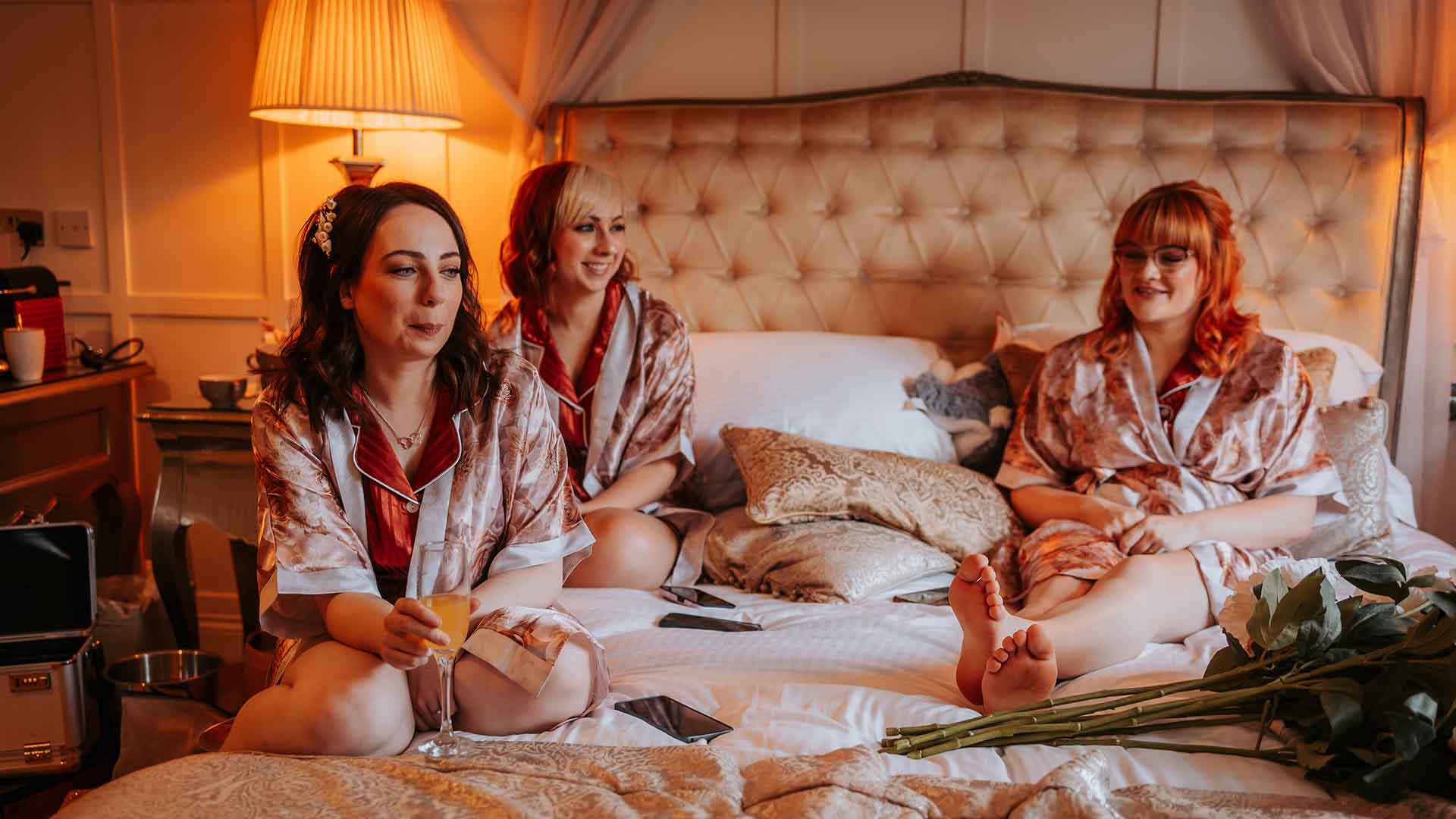 Three brides maids sat on the bed at Mr & Mrs Kendall's wedding