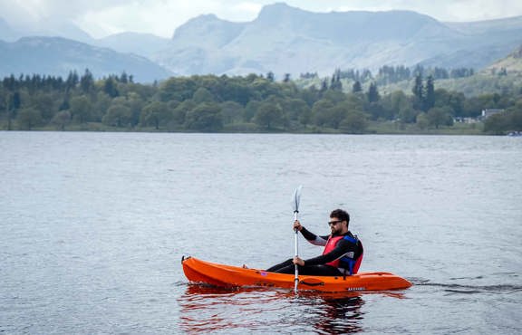 Man on a sit-on-top kayak on lake Windermere