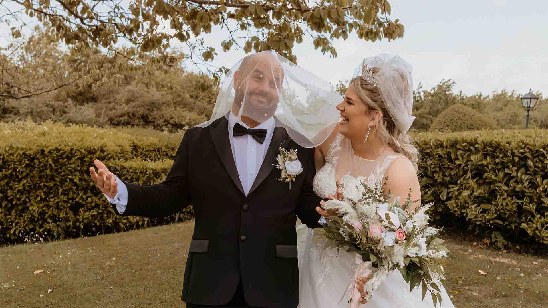 Bride and Groom fooling about on the hotel lawns