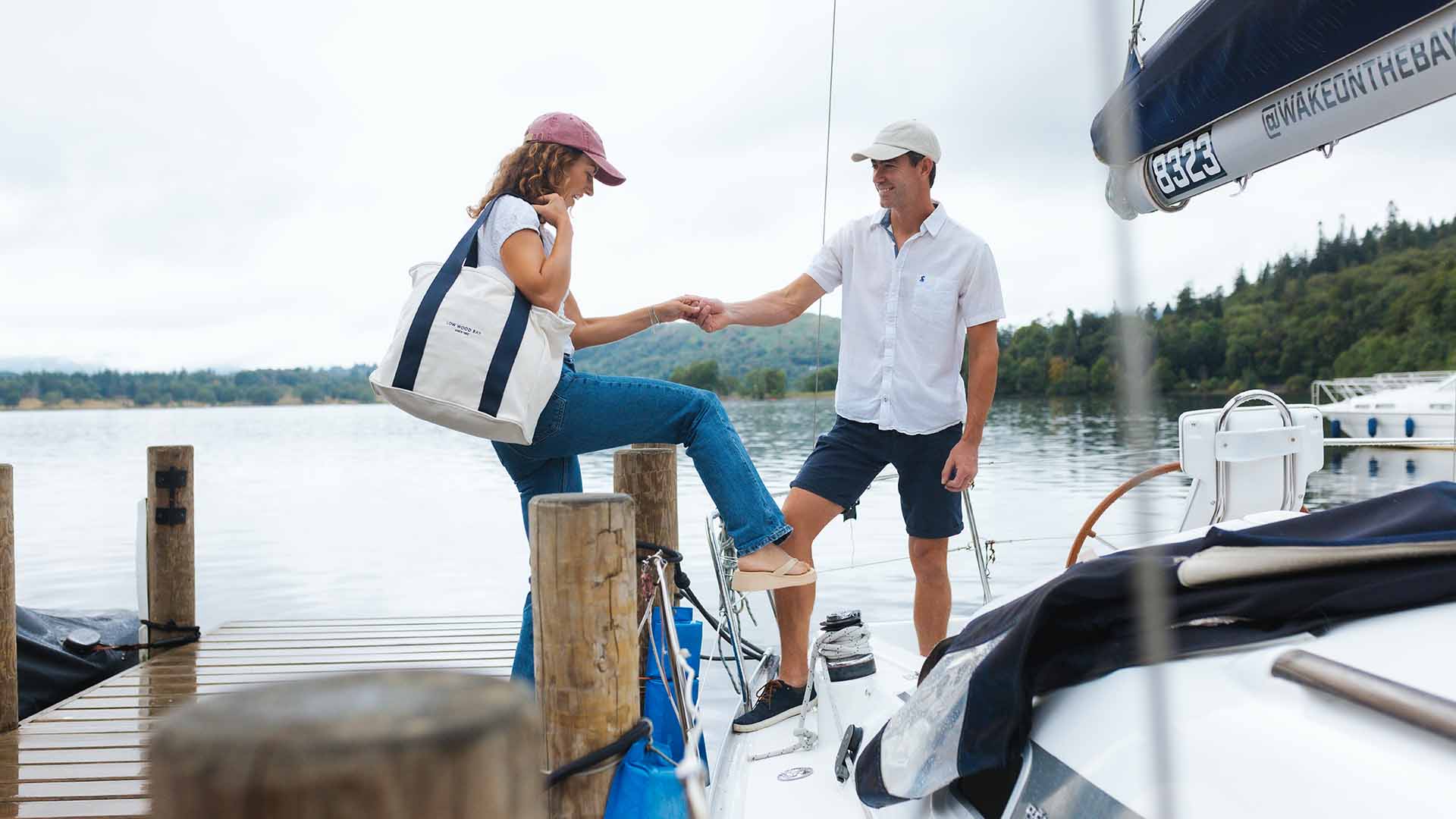 Young woman stepping aboard the charter yacht