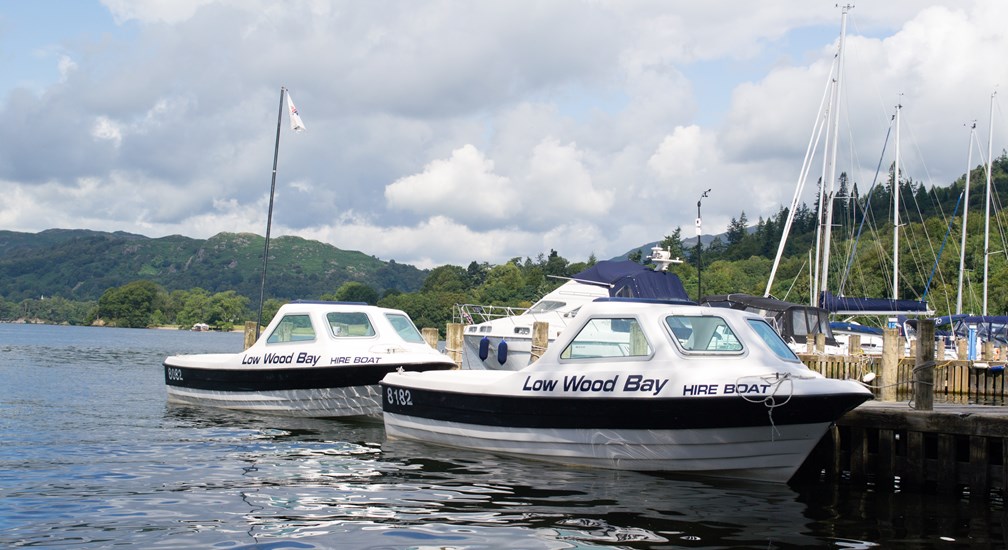 Two hire boats on the water at the Low Wood Bay Watersports Centre