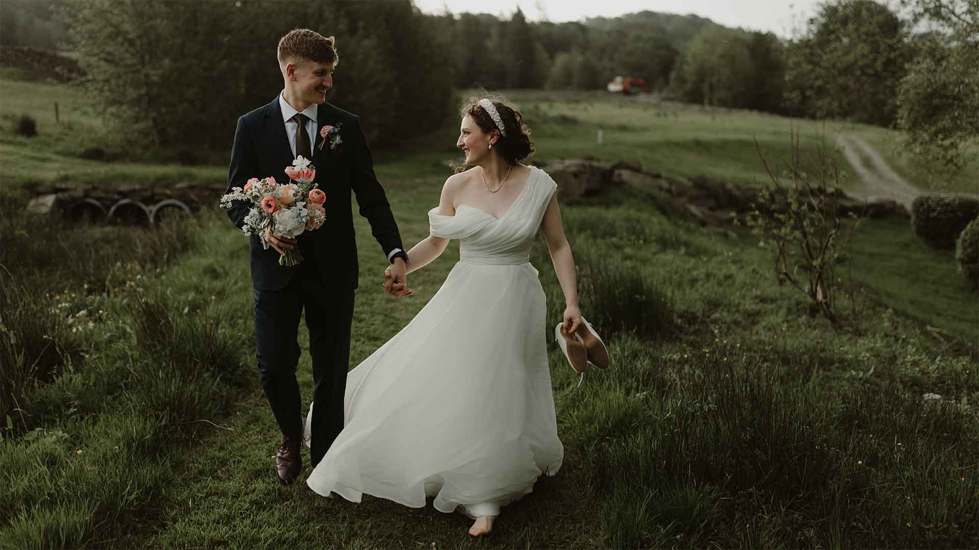 Couple walking through the Low Wood Bay hotel grounds