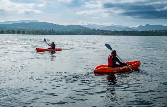 Two women in sit-on-top kayaks