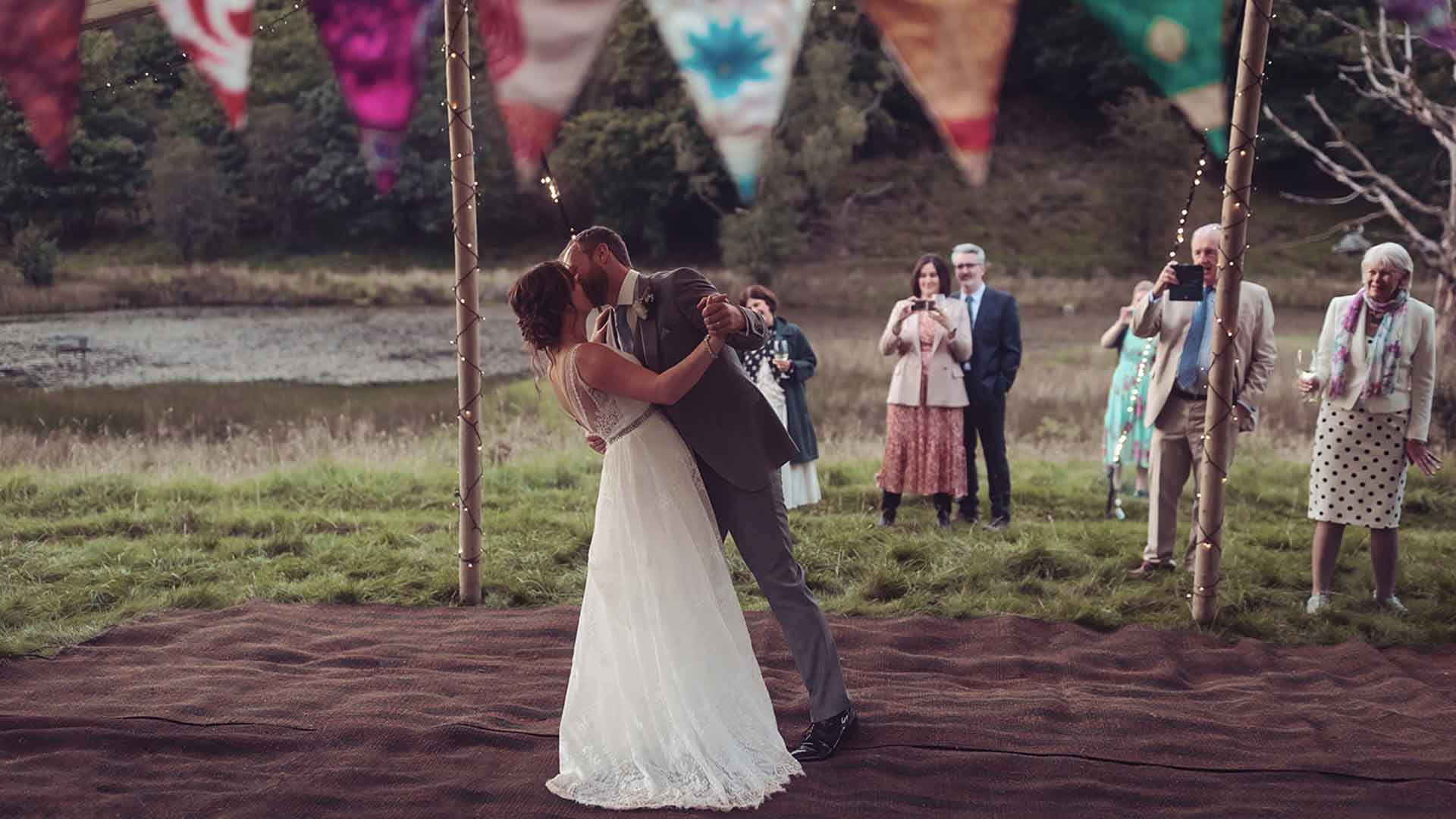 Newly weds kiss inside the tent at their wedding function