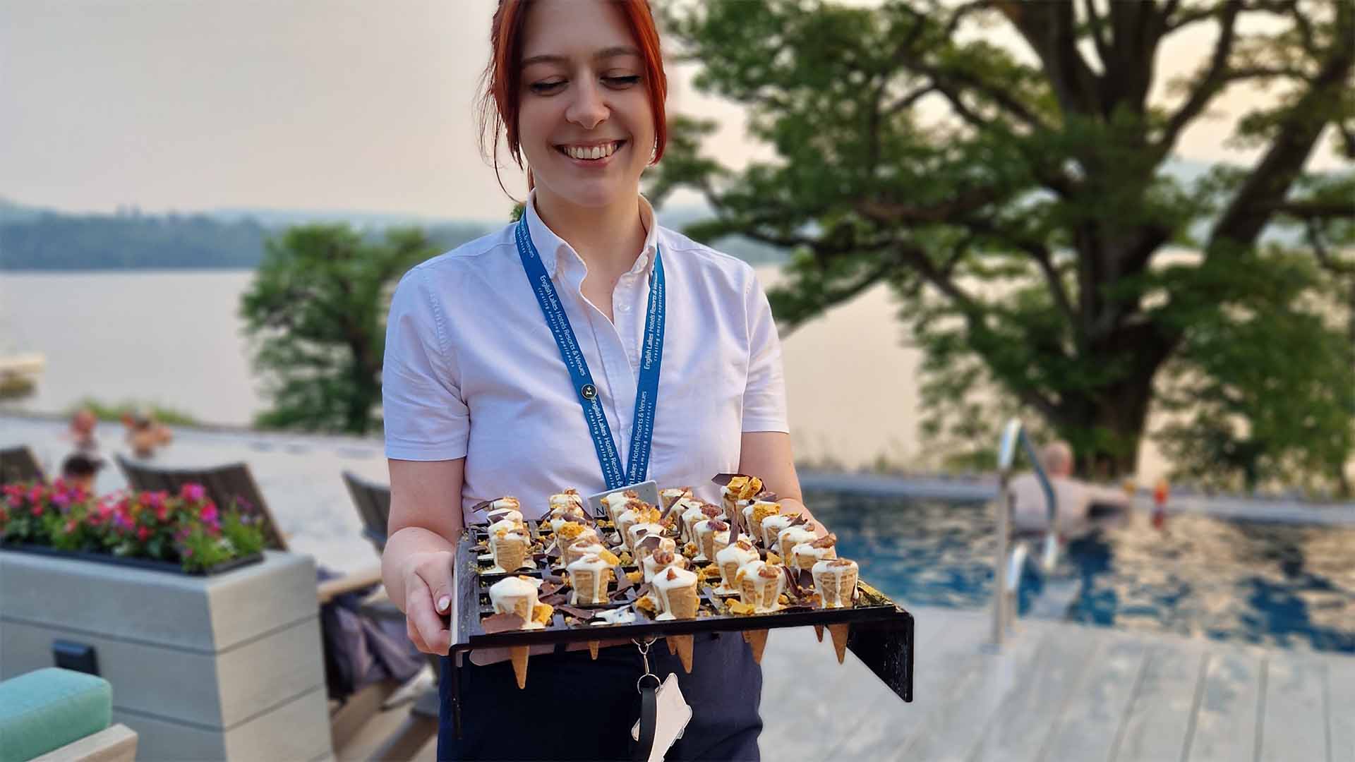 Spatender and tray of small ice creams in cones