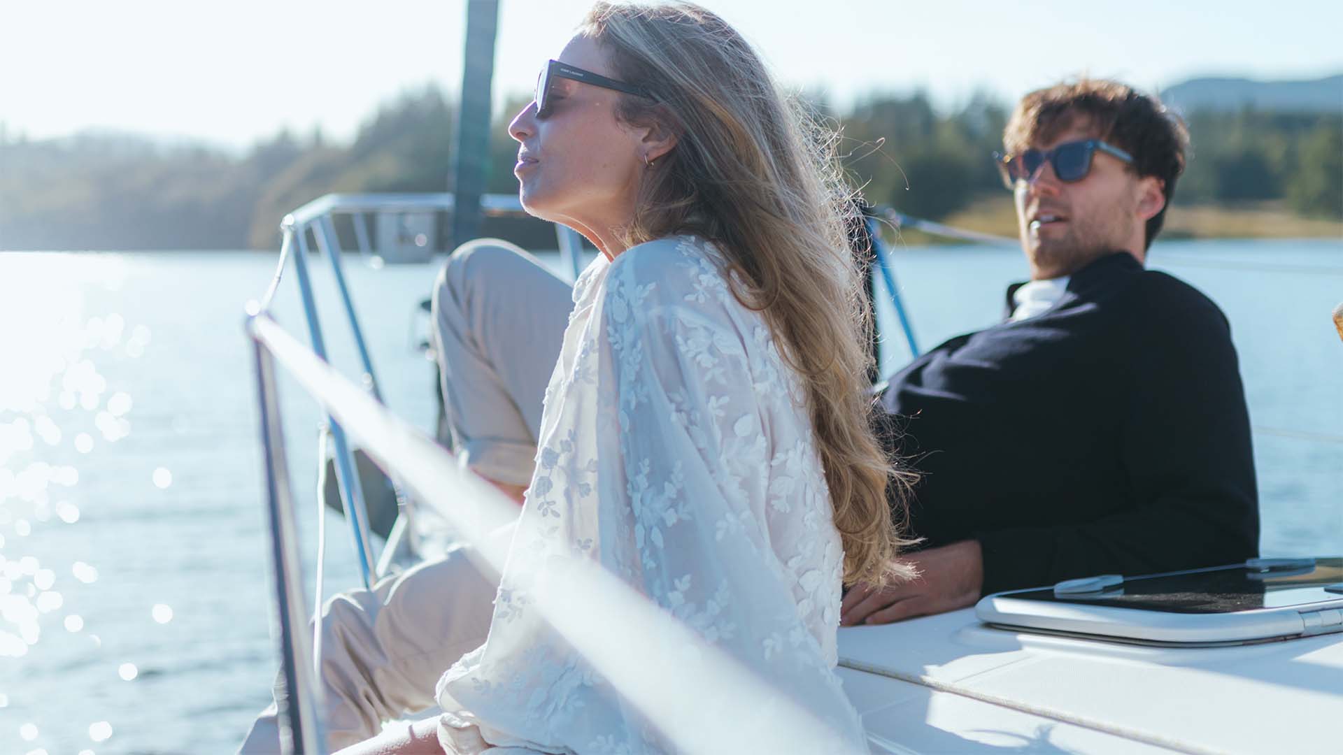 Couple relaxing on the deck of a chartered yacht sailing on lake Windermere