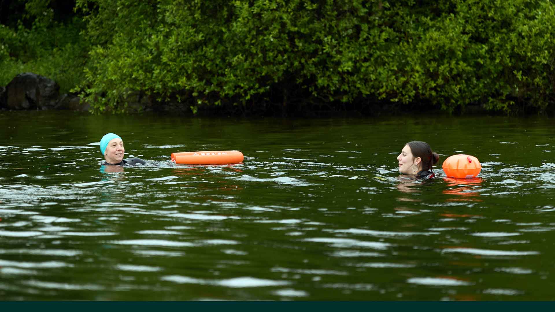 Swimming guide and swimmer in the lake water