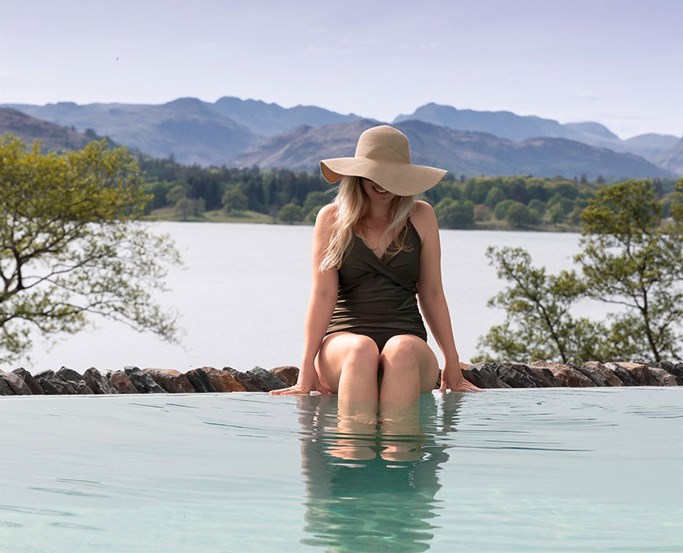 Woman sat by side of the Infinity Pool