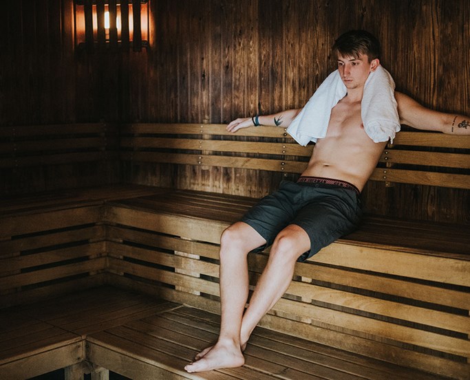 Young man enjoying the sauna at The Sandpiper Club