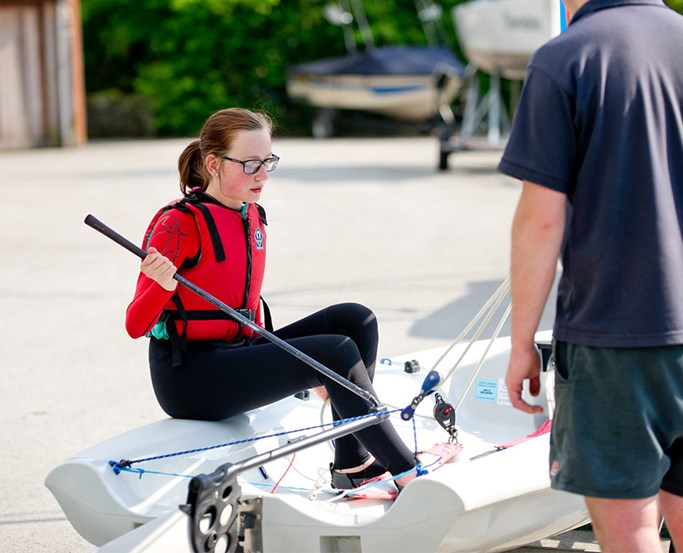 Young woman learning to sail at Low Wood Bay Watersports Centre
