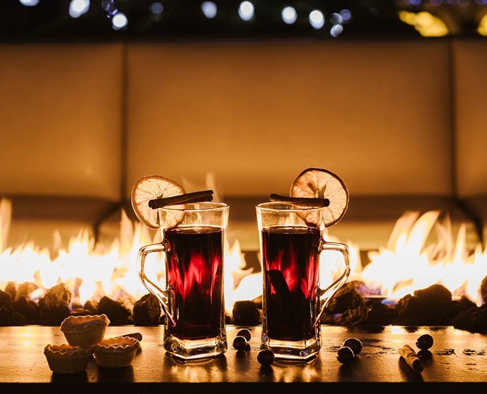 Two drinks lined up on the firepit at Blue Smoke
