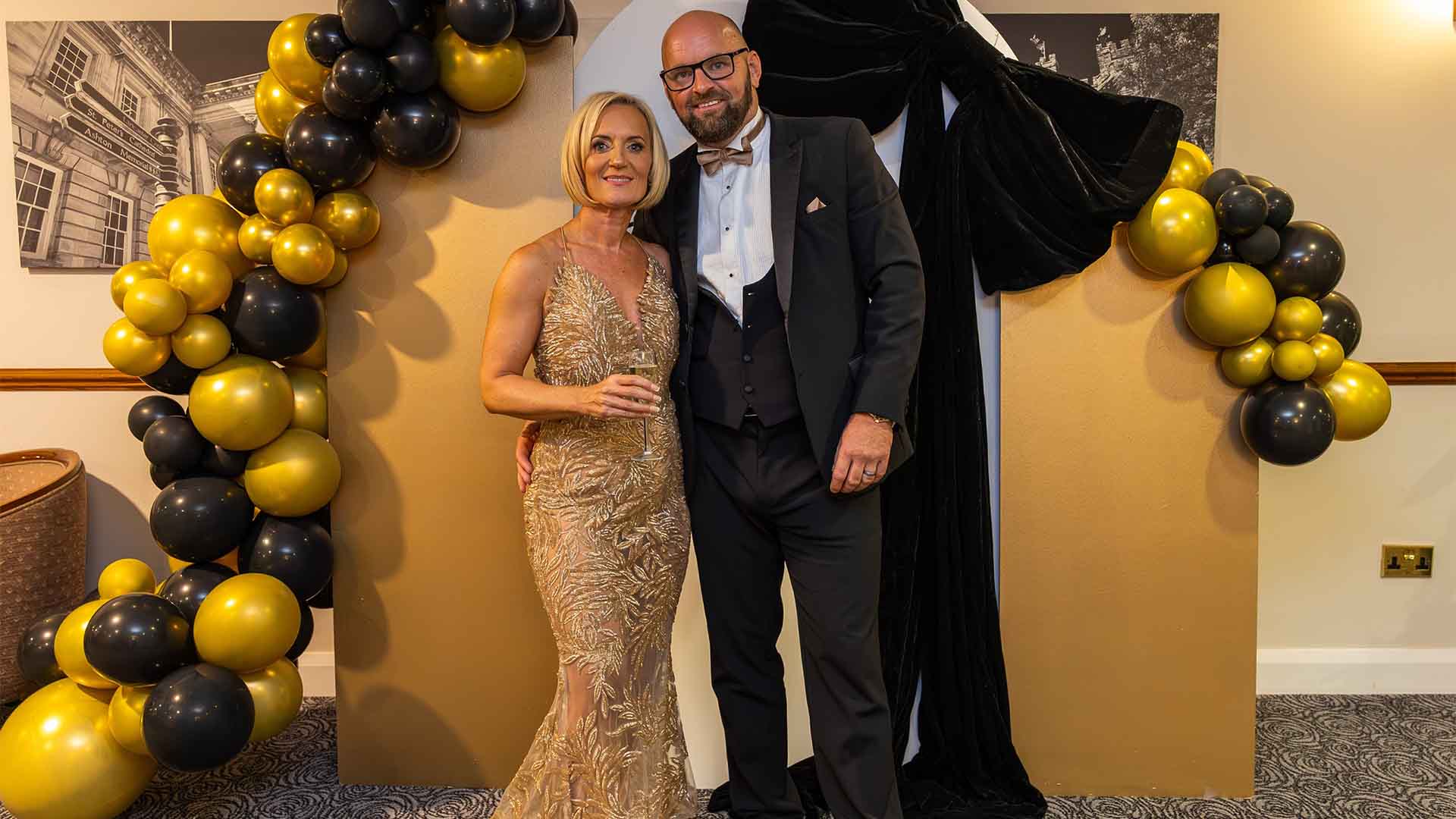 Natalie and Peter beneath a decorative display