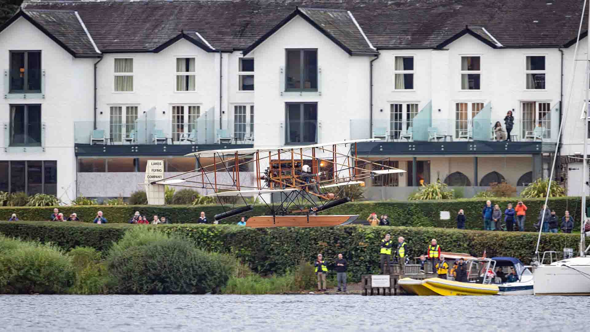 The Wings over Windermere plane flying past Low Wood Bay