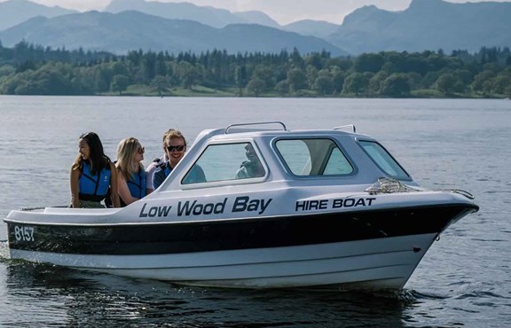 Hire boat on lake Windermere with three passengers