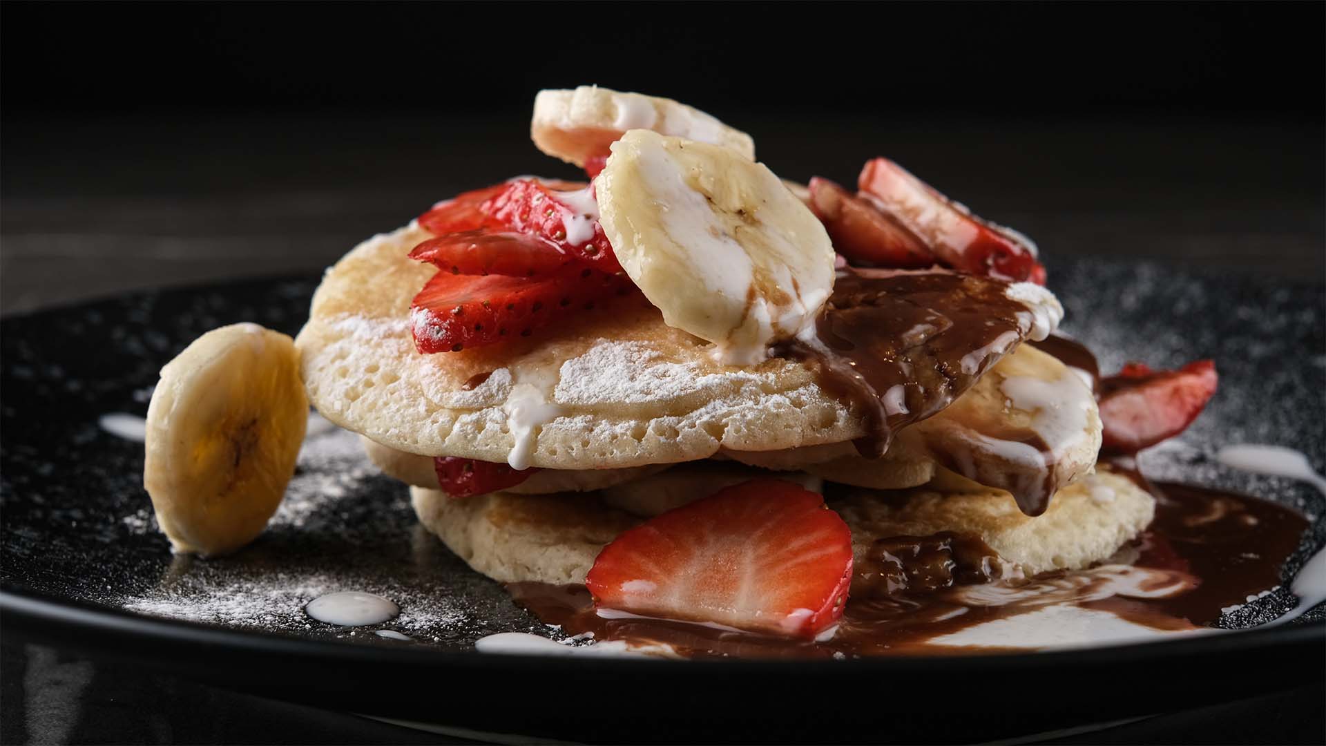 Stacked pancake with bananas and strawberrys