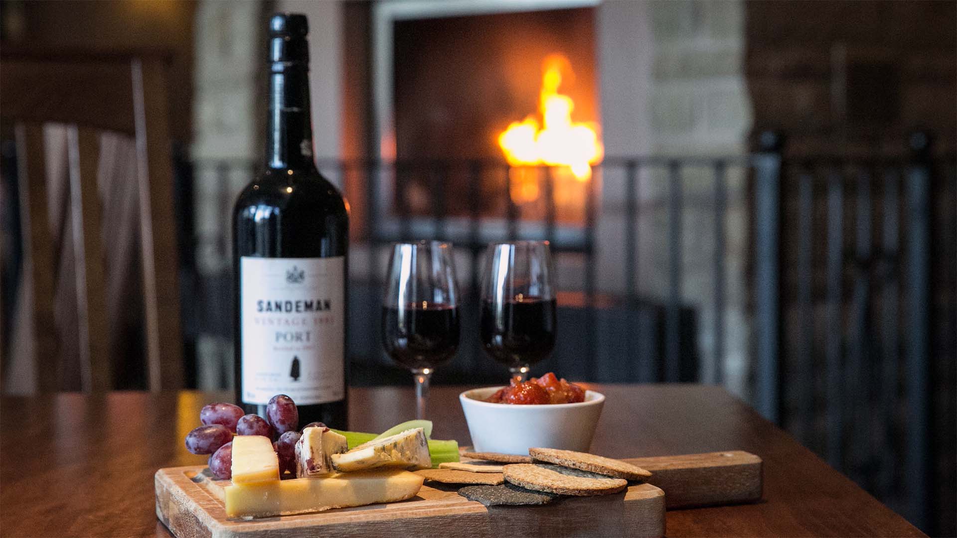 Cheese board with a bottle of Sandeman Port