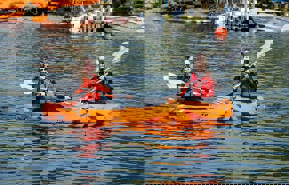Two women on sit-on-top kayaks on lake Windermere