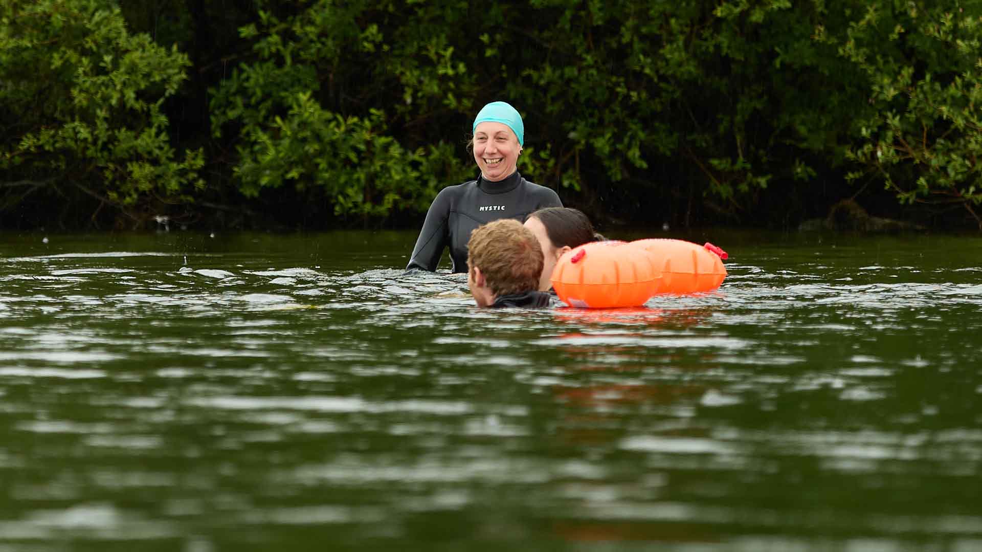 Claire Wilson in the water with 2 other swimmers