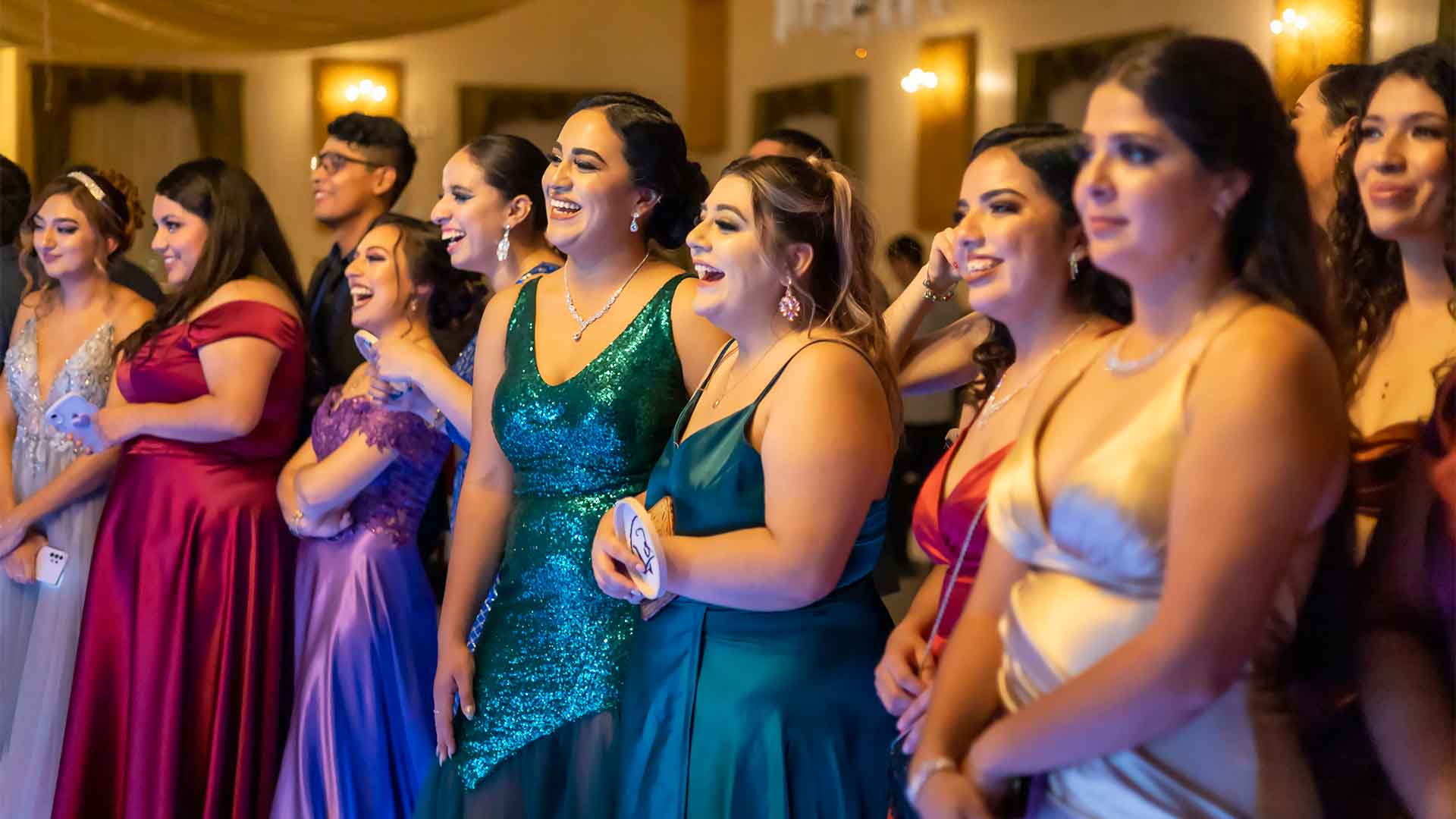 Line of young people stood watching at a prom
