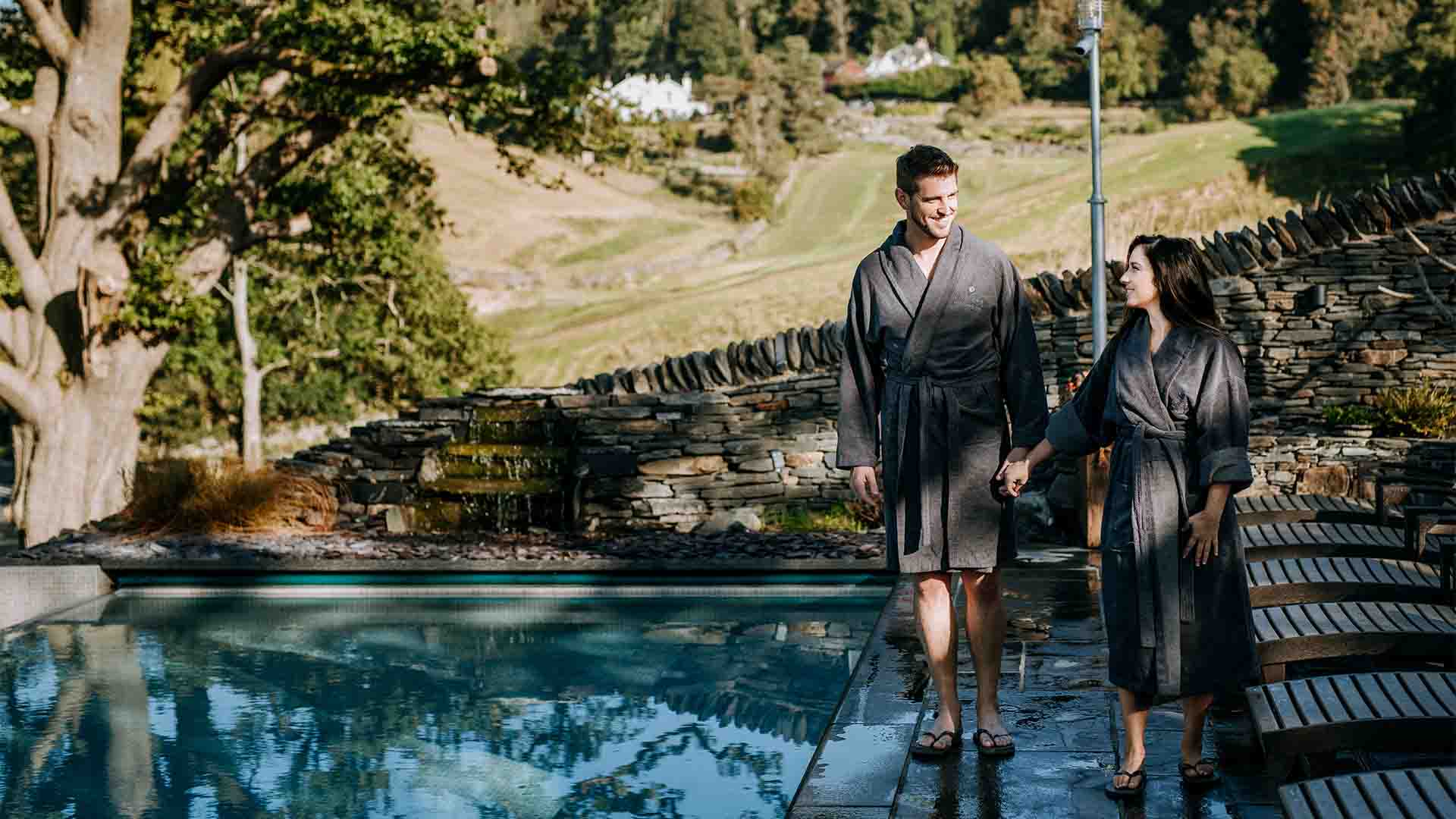 Couple walking alongside the infinity pool