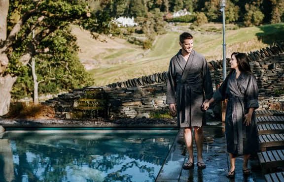 Couple walking by the outdoor infinity pool