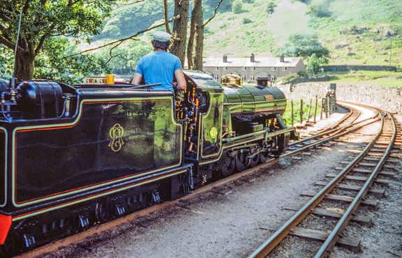 Man driving steam train La'al Ratty