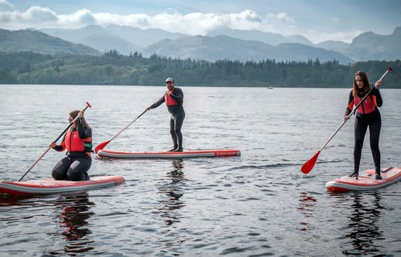 Small group on a hire paddleboards on lake windermere