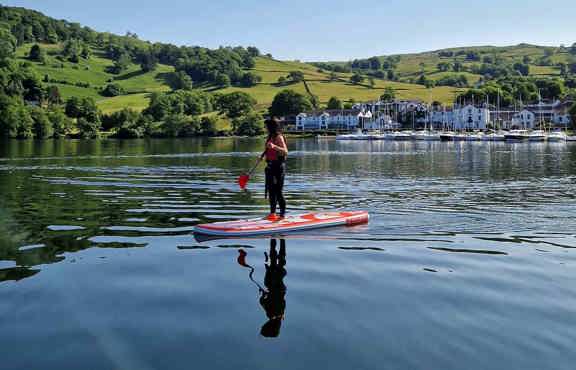 Young woman paddleboarding on Windermere