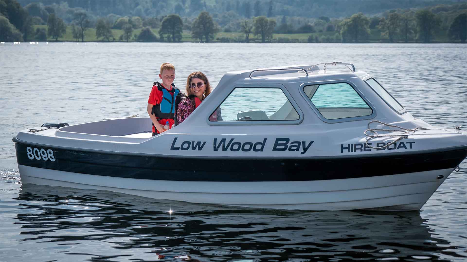 Mother and son in a hired motor boat on lake Windermere