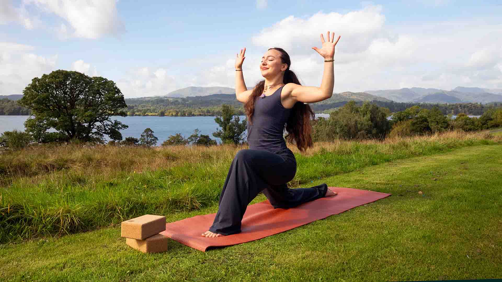 Mille the yoga instructor in a pose on the fell above Low Wood Bay