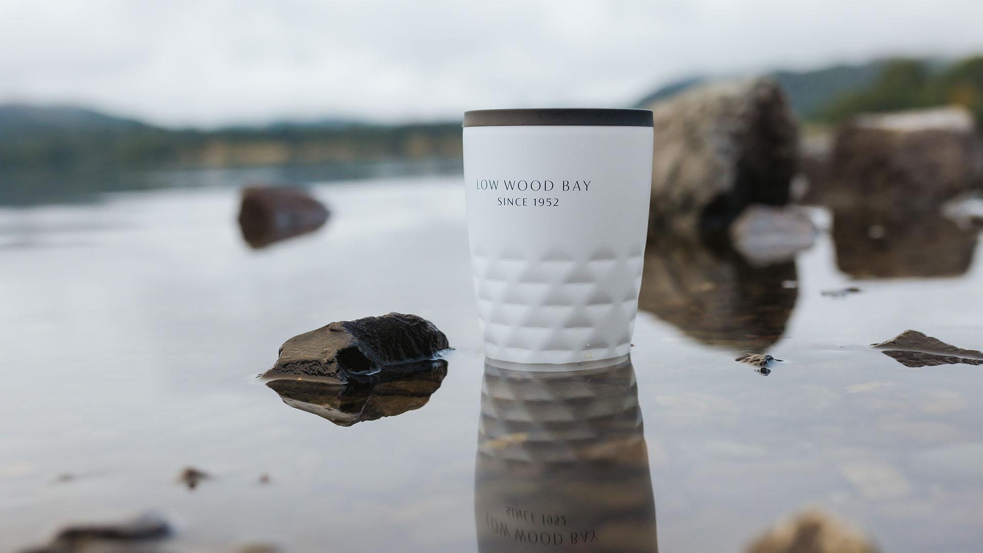 Branded cup stood in shallow water
