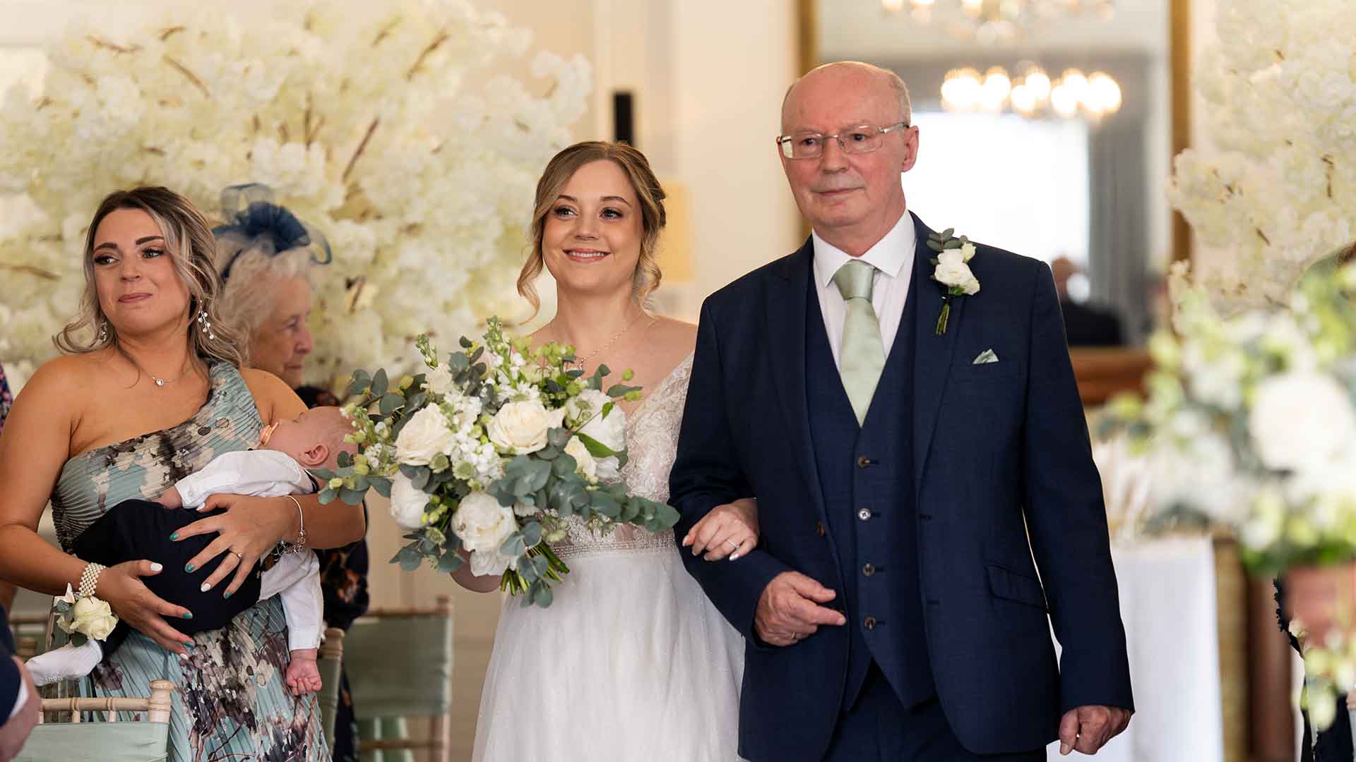 Bride and her father walking down the aisle in the Buckley Room at Low Wood Bay