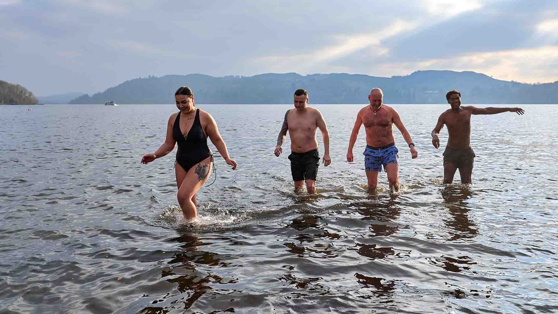 A group of bathers leaving the water of the lake