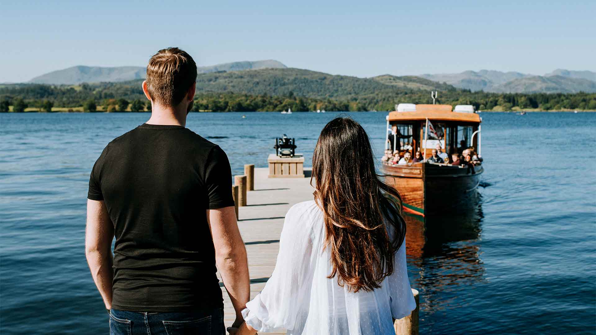 Couple walking towards a lake steamer