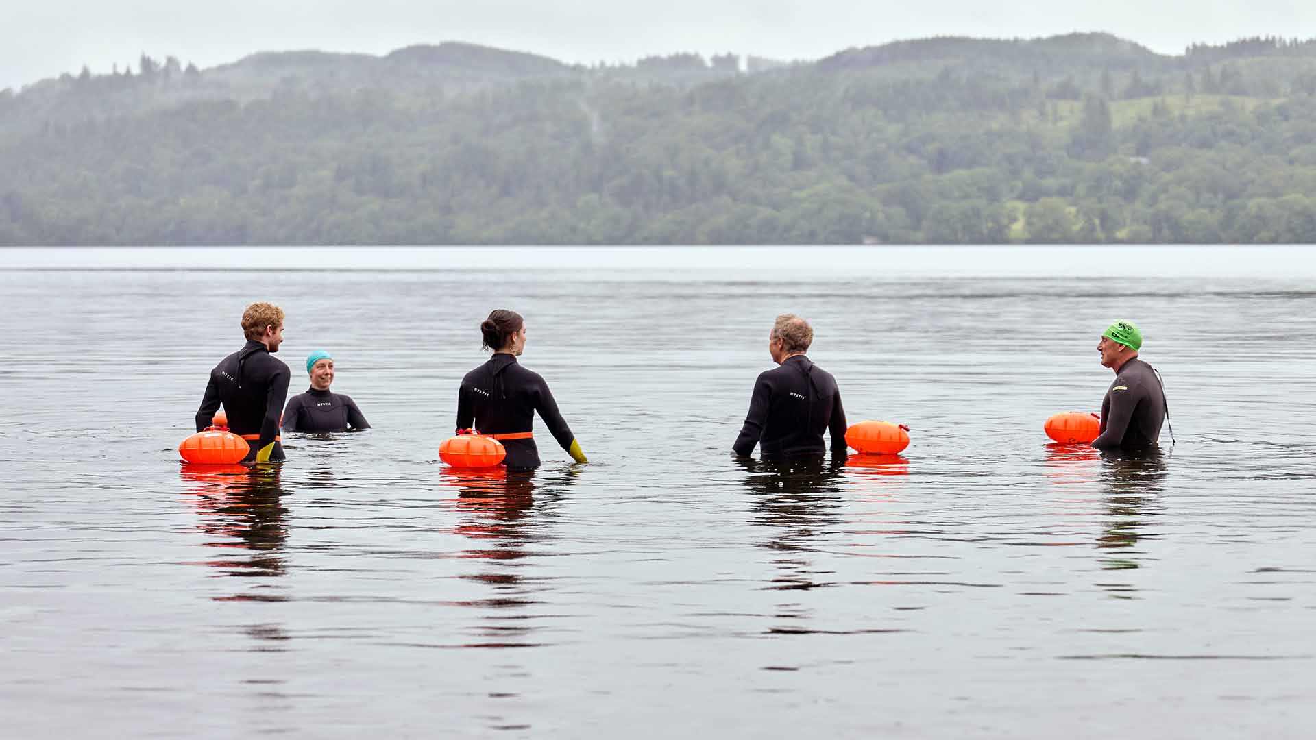 Open water swimming group getting accustomed to the lake water temperature