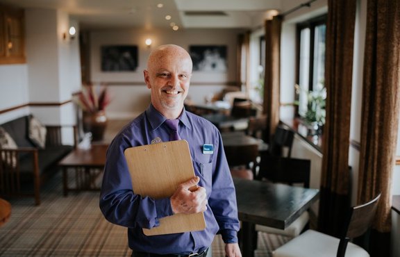 Lancaster House team member with clipboard