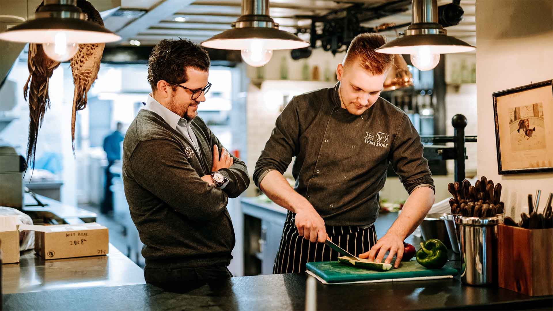 Adam watching chef prep food