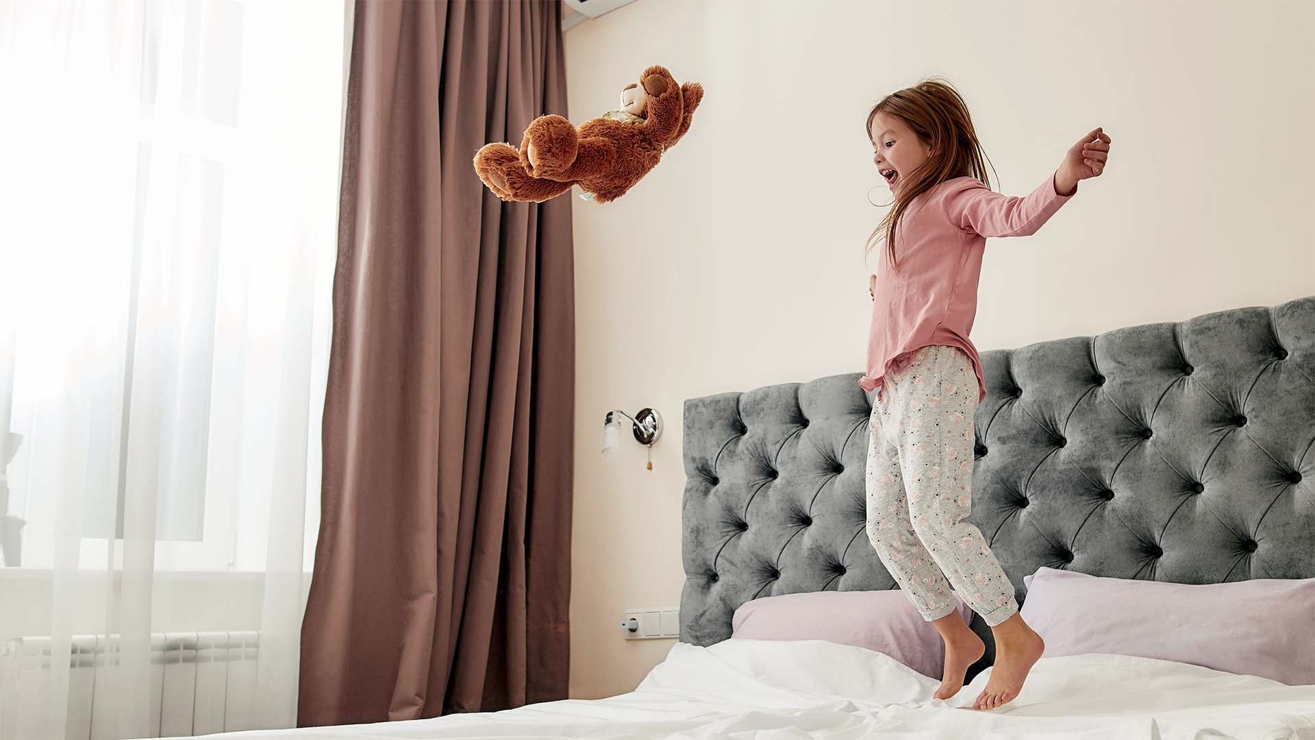 Child playing on a bed