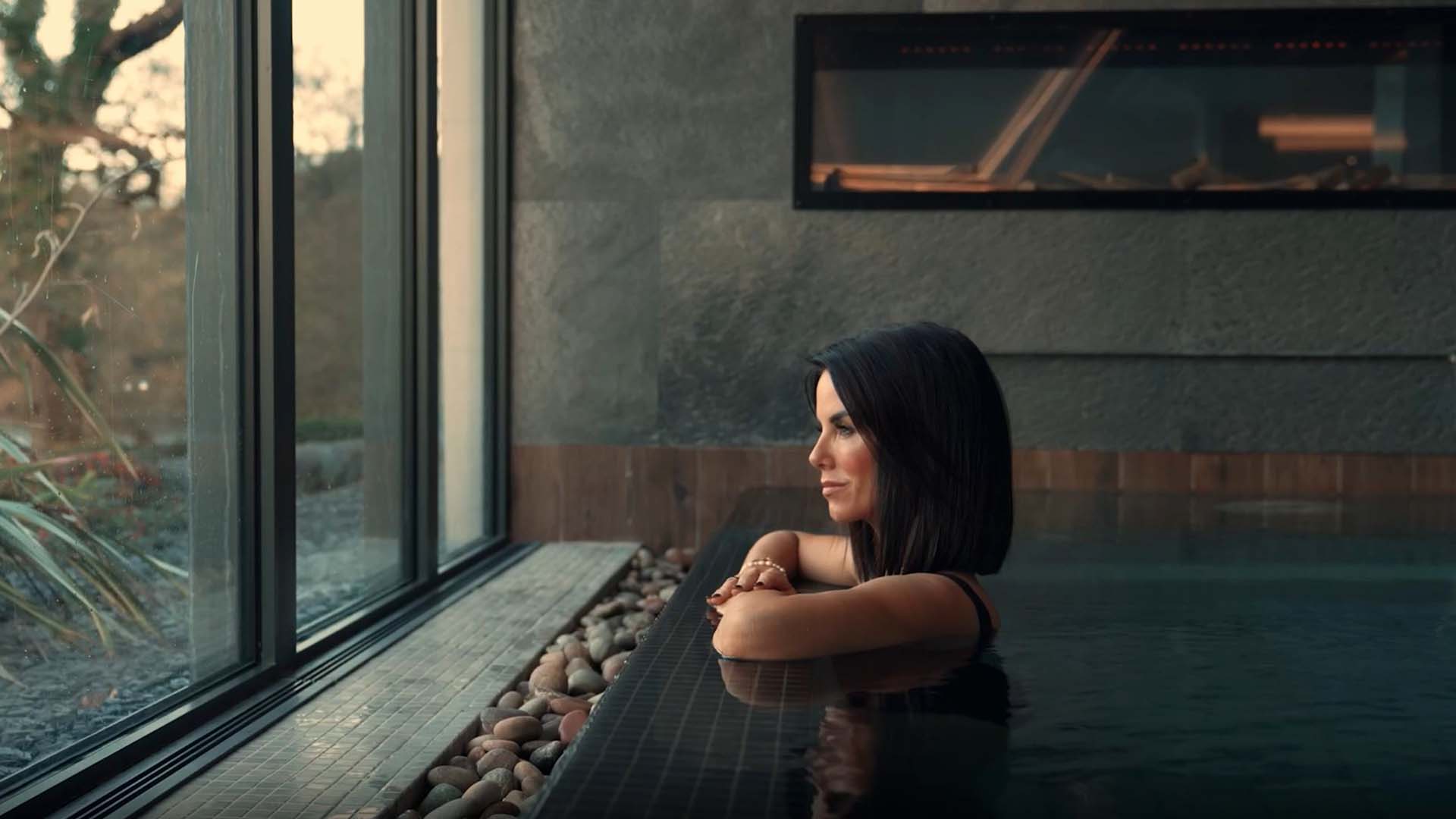 Young woman in the indoor thermal pool at the Spa