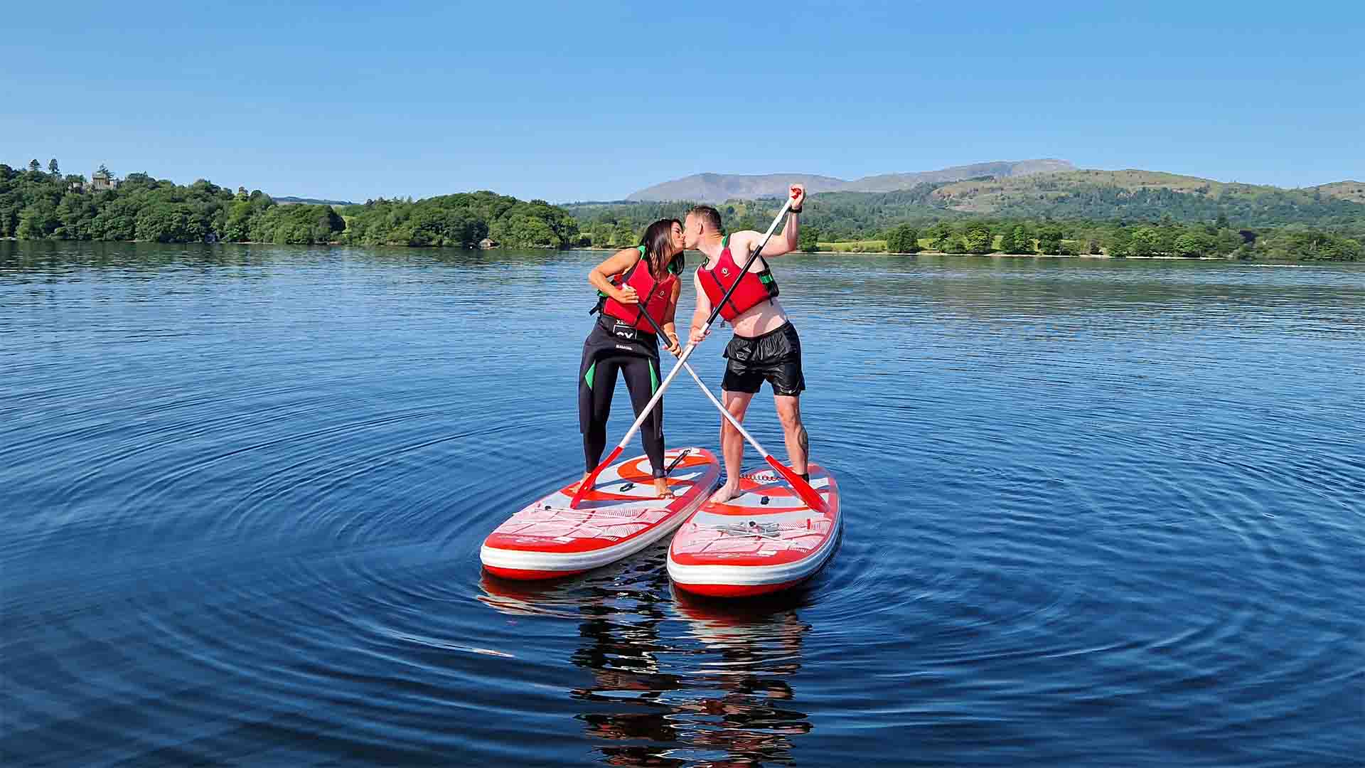 Couple on paddleboards on lake Windermere