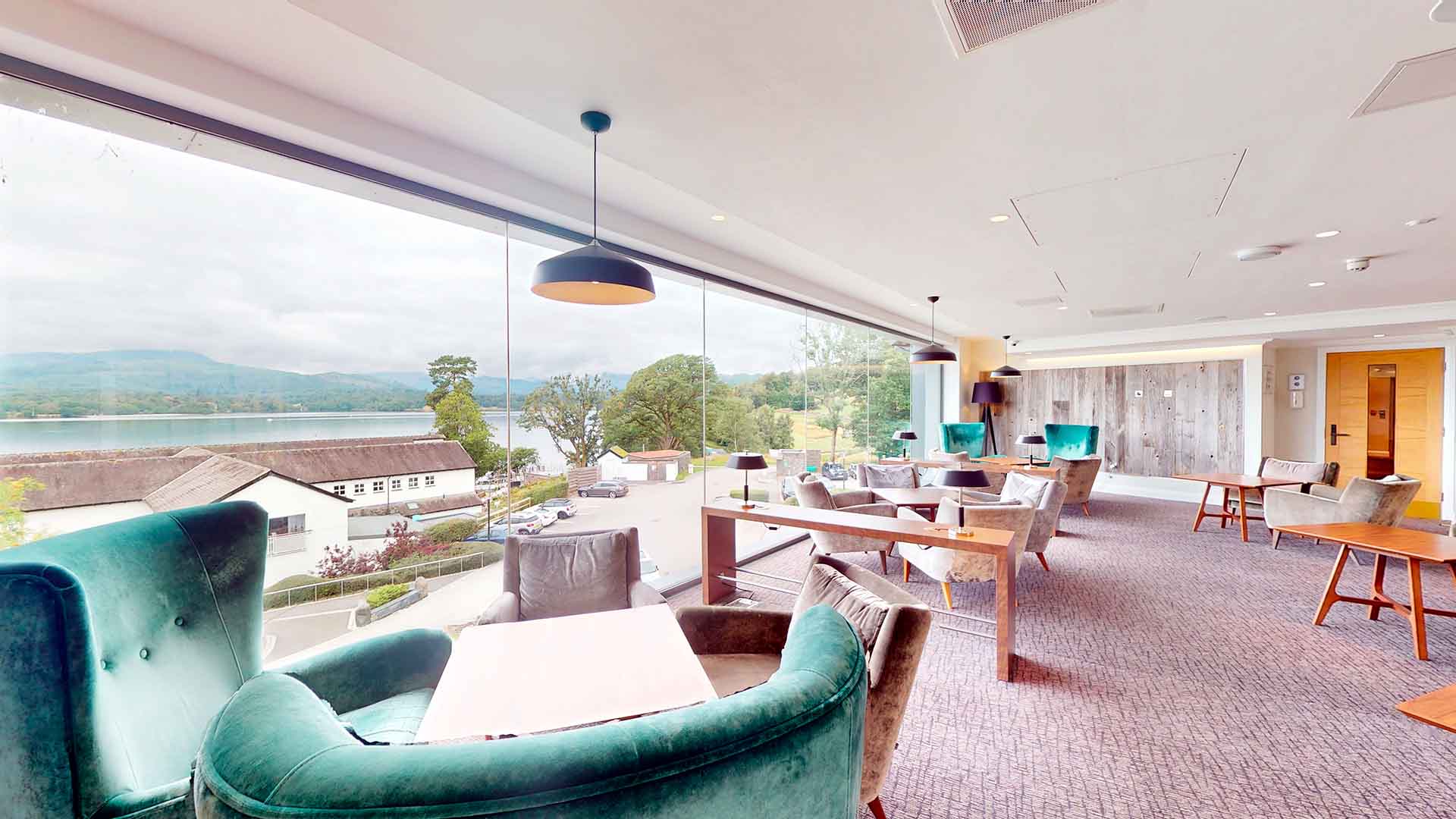 Floor to ceiling views of lake Windermere from the Winander Club Lounge & Bar