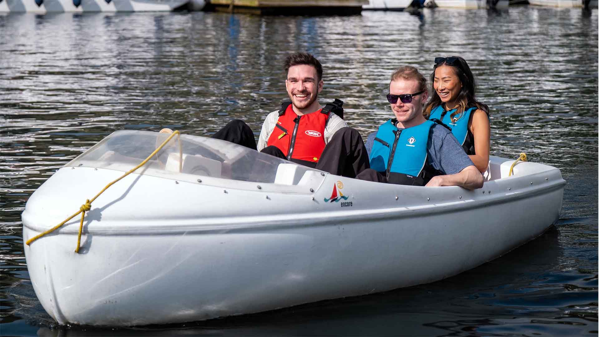 Three people in a pedalo