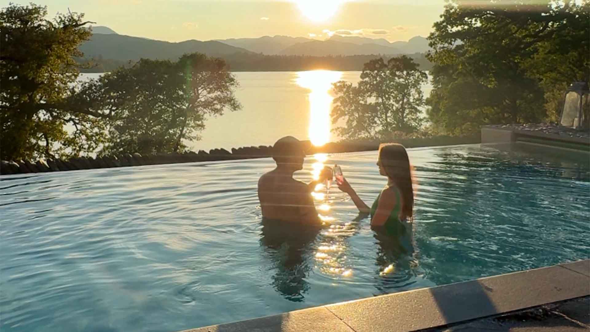 Couple in the pool at sunset
